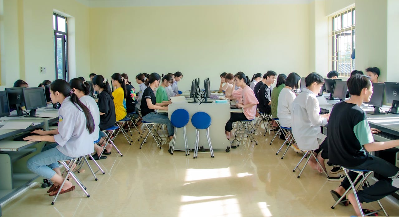 Students engaging in a group study session at a university computer lab, focused and collaborative.